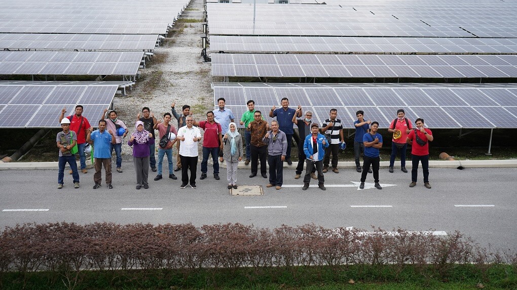 Gading Kecana Team with solar panels in background